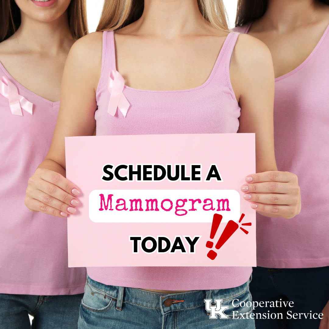 three women wearing pink holiding pink sign