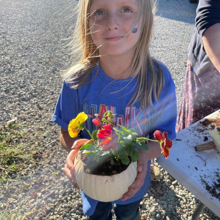  girl holding pumpkin planter