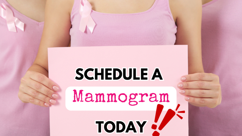 three women wearing pink holiding pink sign